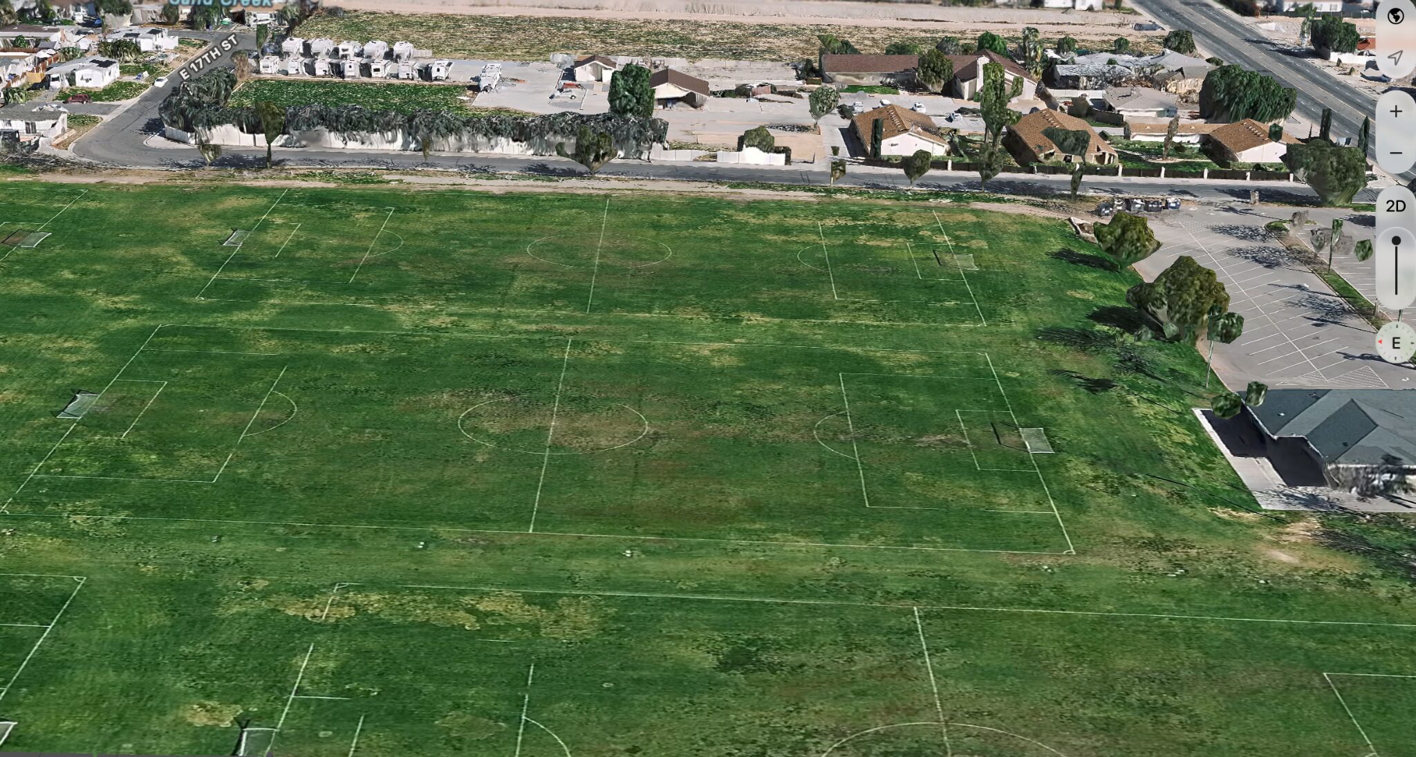 Aerial view across the existing soccer fields and surrounding neighborhood